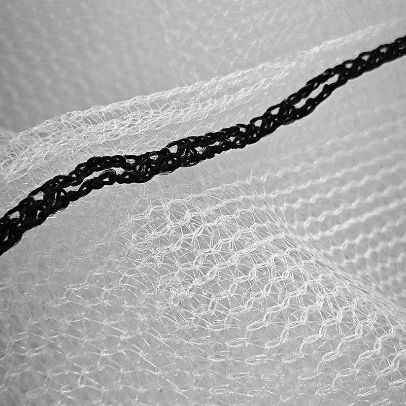 White debris netting with black streaks